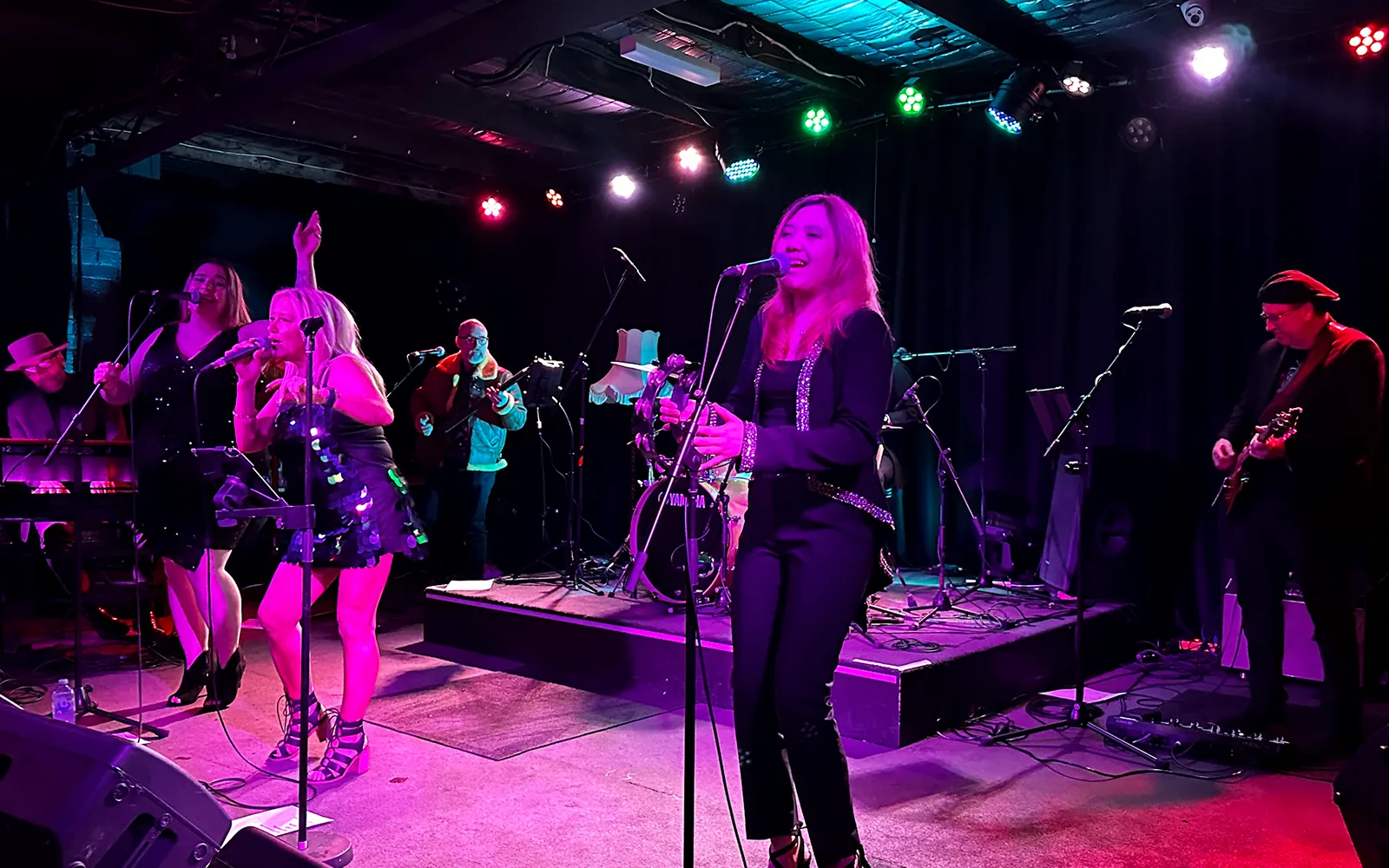 Teenie singing at the front of The Adele Show during a full-band performance