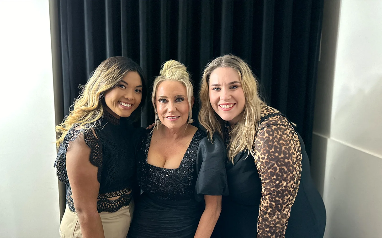 Teenie standing with two fellow Adele Show vocalists backstage