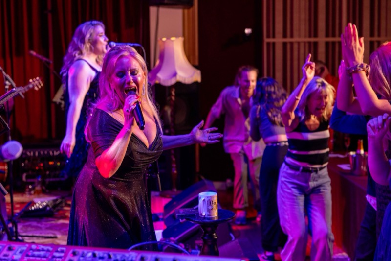 Michelle Morrison singing as the crowd dances
