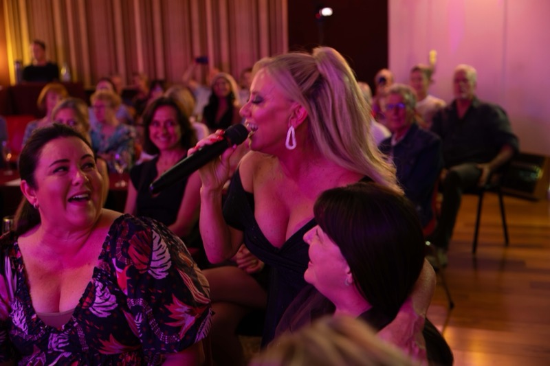 Michelle Morrison singing among the audience