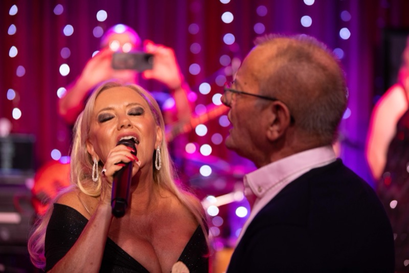 Michelle Morrison singing to an audience member