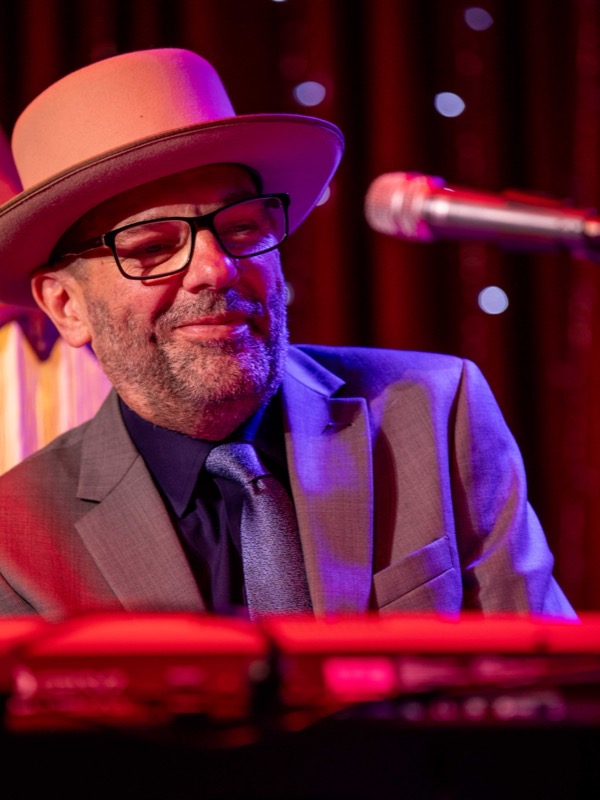 The keyboard player smiling at the keys