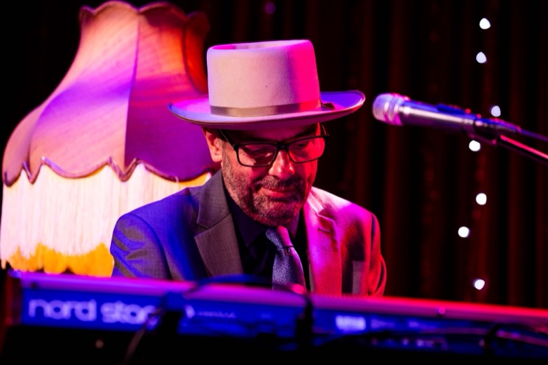 The keyboard player at the Nord beside a vintage lamp