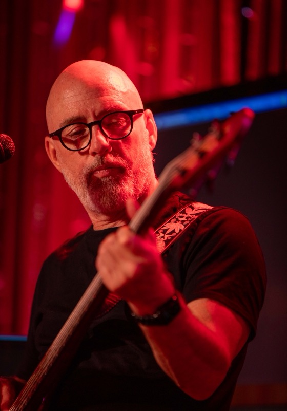 The bass player in red stage light