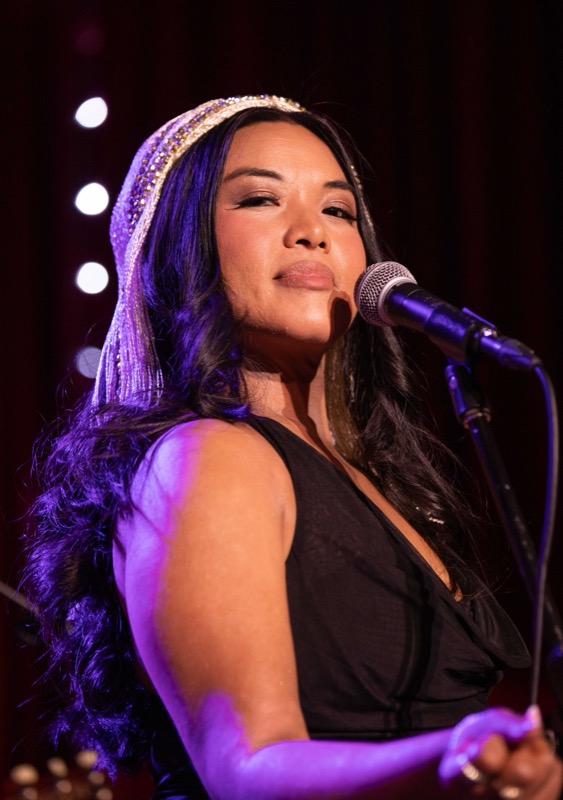 Backing vocalist smiling at the microphone